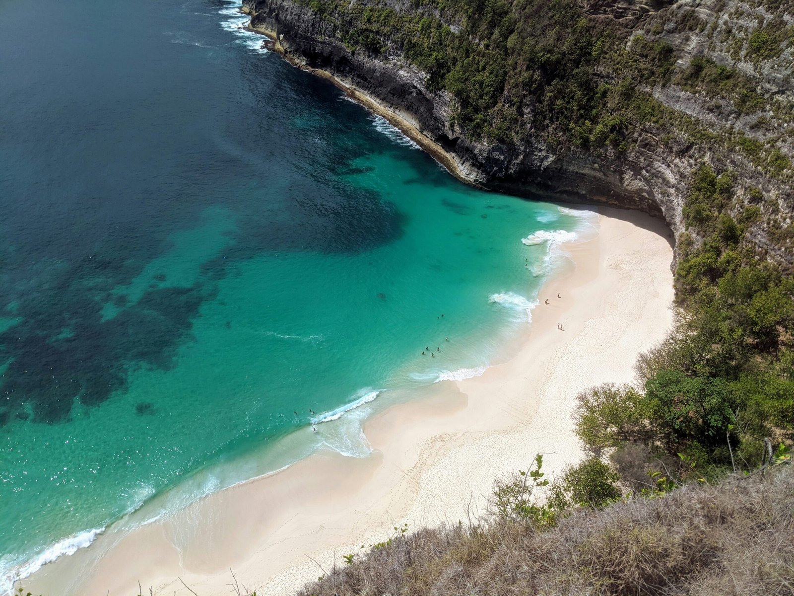 Turquoise water meeting a secluded white sand beach in Bali